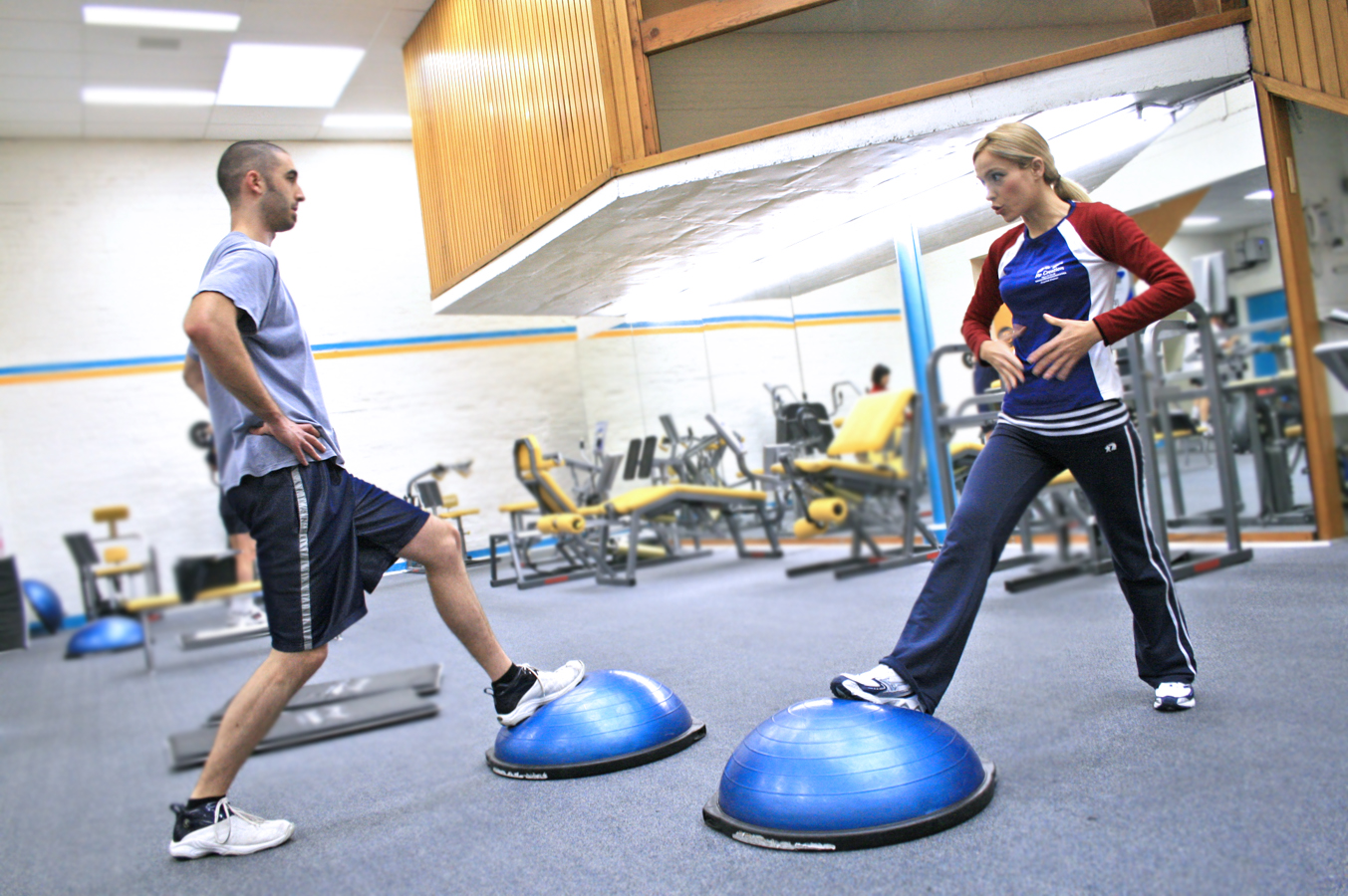 Two_people_in_a_gym_using_BOSU_balls Two_people_in_a_gym_using_BOSU_balls